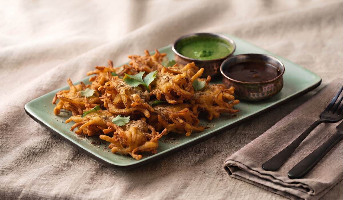 Pyaaz Pakora – Sliced onions in spiced gram-flour batter, fried till crunchy (Pure Veg, Chatkara Junction - Snacks) | Desi Chef Restaurant, Bengaluru